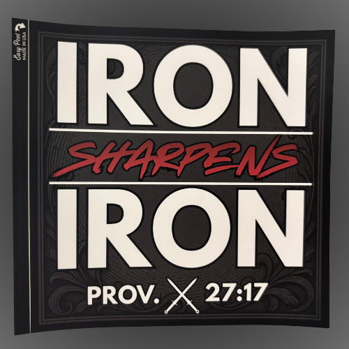 A square black UV-safe sticker with large white text reading 'IRON IRON' and a red script phrase 'SHARPENS' between the lines, plus 'PROV. 27:17' at the bottom.