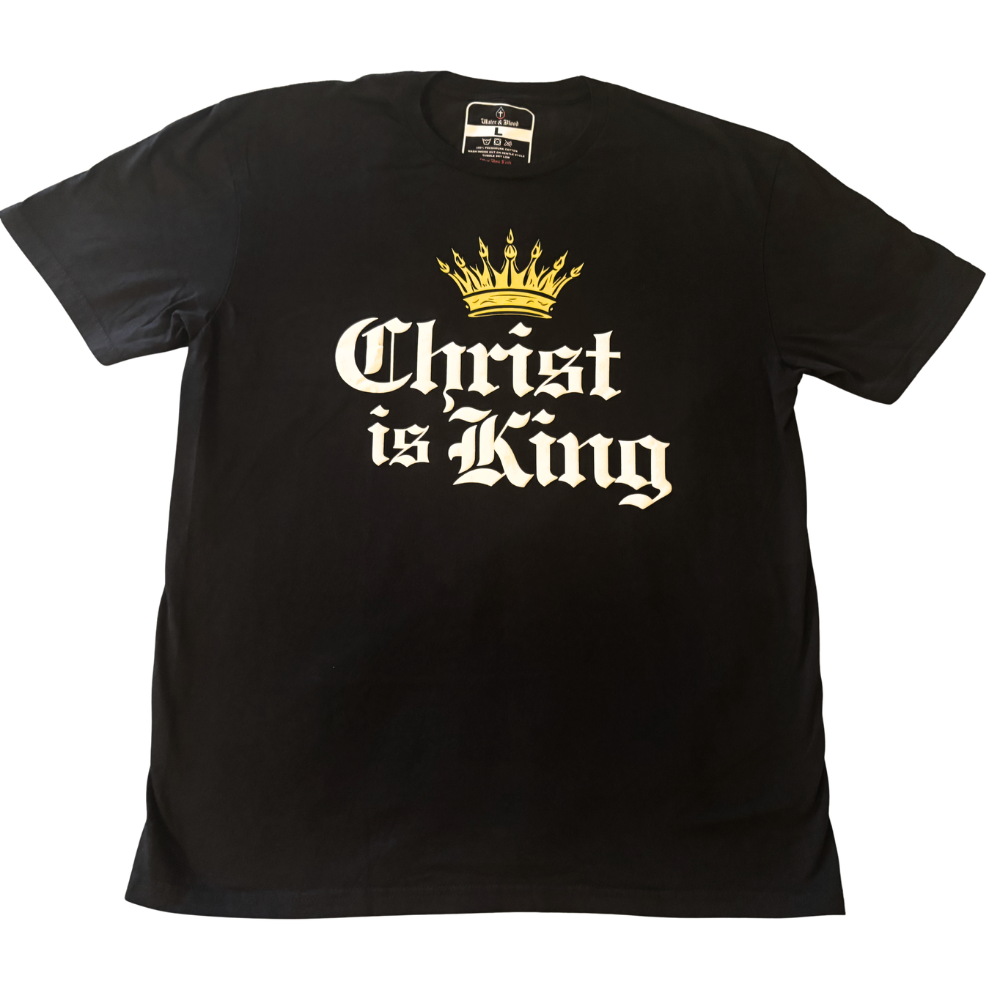 A black short-sleeve t-shirt with a graphic print on the front featuring a gold crown above the text 'Christ is King' in a white Old English font, displayed flat against a white background.