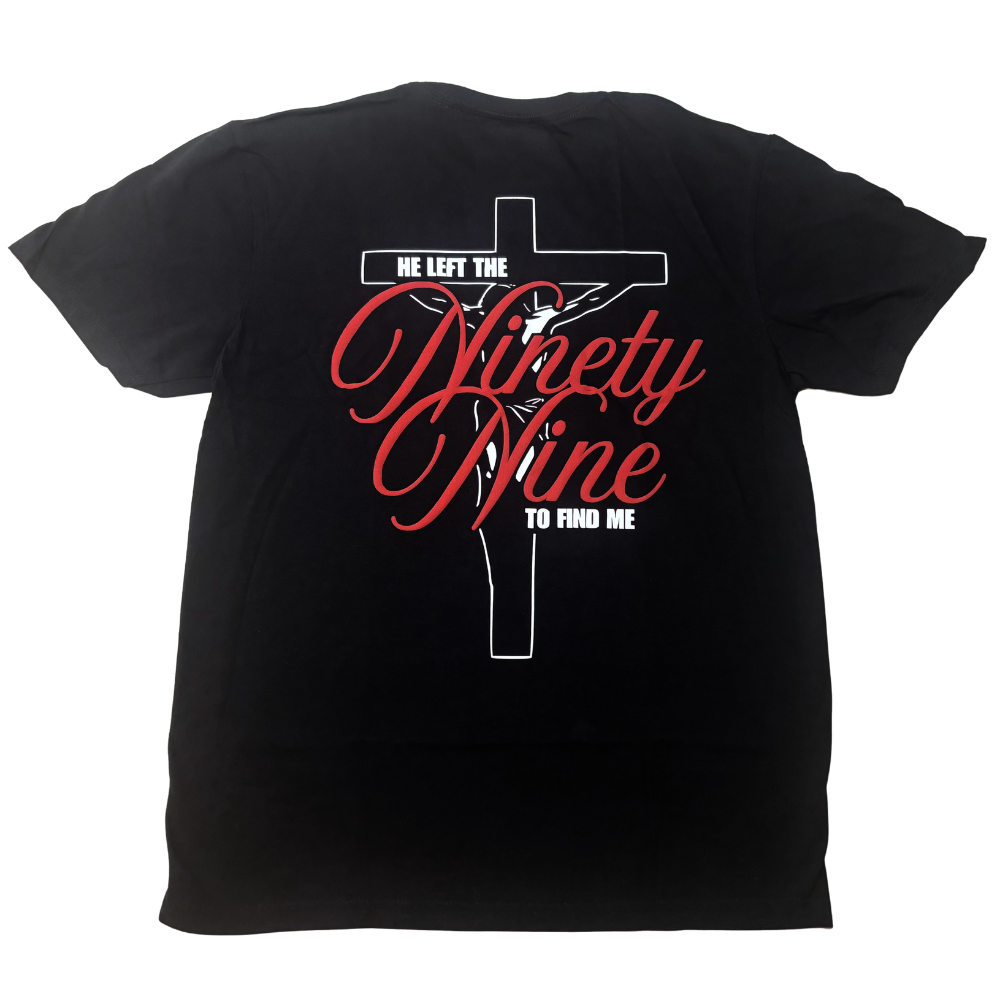Christian black, short sleeve t-shirt shown from the back with raised, red 3D text that says "he left the 99 to find me" with a white Crucifix in the background. The design is based on Jesus' parable of the lost sheep from Luke 15.