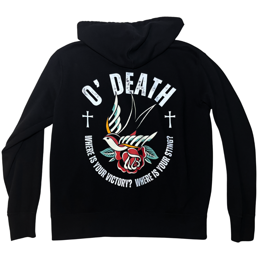 A black zip-up hoodie shown from the back, featuring a large graphic print with the text 'O' DEATH' and 'WHERE IS YOUR VICTORY? WHERE IS YOUR STING?'. The graphic includes a white dove, a red rose, and two white Christian crosses on a plain white background.