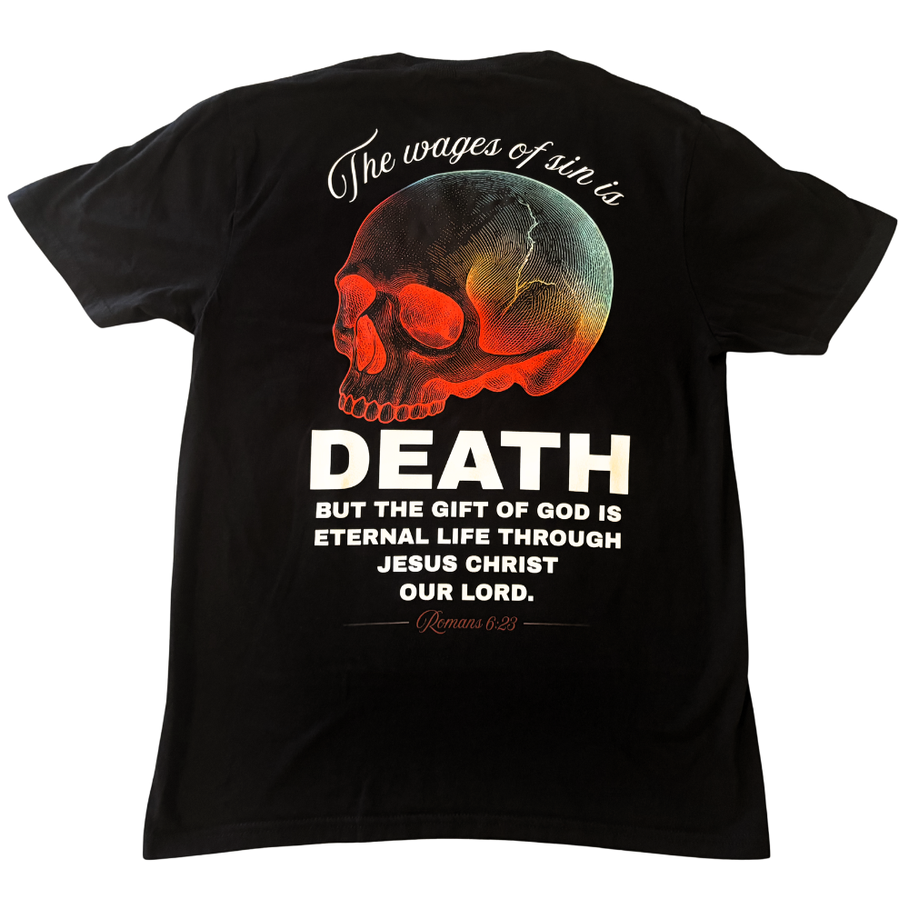 A black short-sleeve Christian apparel t-shirt shown from the back, featuring a large graphic print of a skull with a red, gold, and teal gradient, accompanied by the text 'The wages of sin is DEATH BUT THE GIFT OF GOD IS ETERNAL LIFE THROUGH JESUS CHRIST OUR LORD. Romans 6:23'.